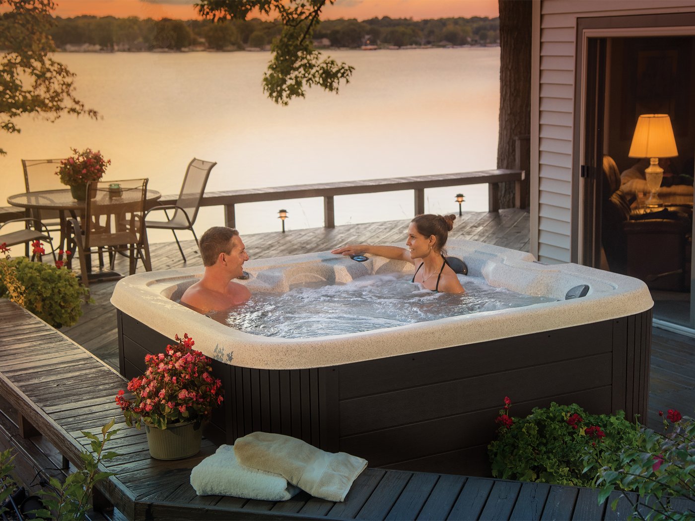 Getaway hot tub on a lakeside deck at sunset